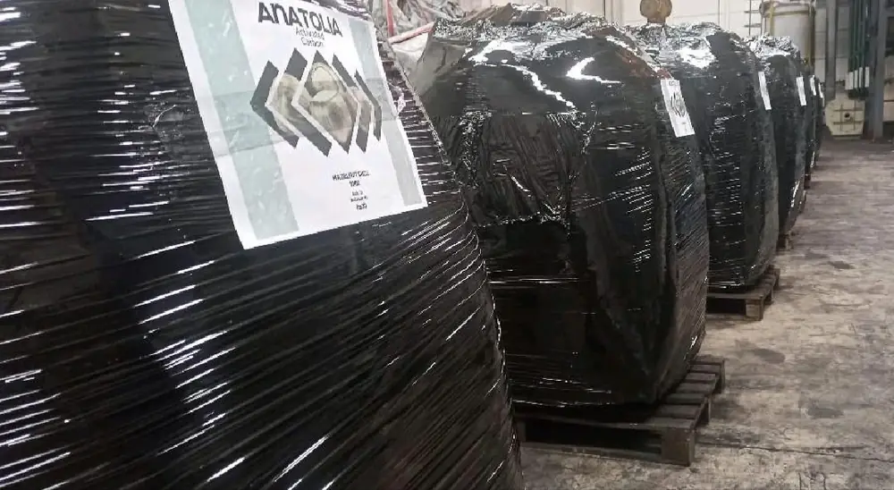 Shipment-ready activated carbon pallets wrapped in black film